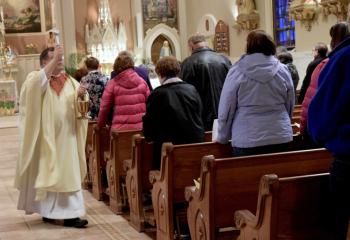 Father Martin Kern performs the sprinkling rite.