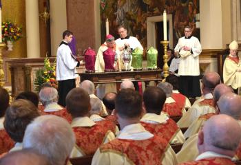 Bishop Schlert prepares three oils – the oil of catechumens, the oil of the sick and holy chrism – that will be used in the administration of the sacraments throughout the Diocese for the year. 