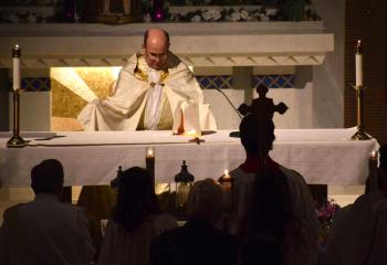 Father Robert George, pastor of Sacred Heart, Bethlehem, celebrates the Mass of the Lord’s Supper March 29 before a veiled ciborium, an altar vessel that holds the consecrated host of the Blessed Sacrament. The Mass inaugurates the Easter Triduum that begins with Jesus’ last supper with his disciples