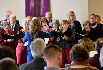 The choir at St. Francis de Sales sings a hymn during Mass on Palm Sunday.