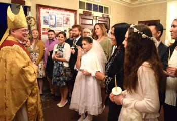 Bishop Schlert welcomes new members of the faith to the Easter Vigil at the cathedral.