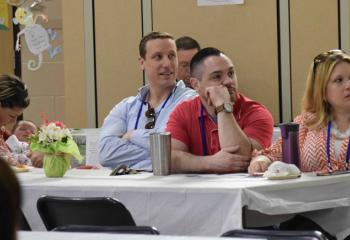 Couples enjoy breakfast while being welcomed to the conference.