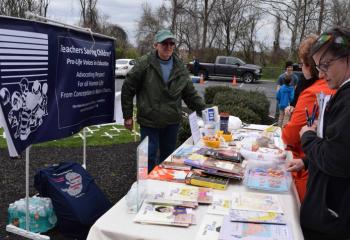 Supporters view materials at one of the vendor displays at the festival.