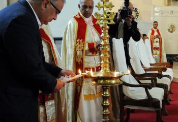 Easton Mayor Sal Panto, left, lights the lamp under the guidance of Rev. Dr. James Kallumkal, provincial superior of Marymatha Province, Vincentian Congregation, Kerala, India.