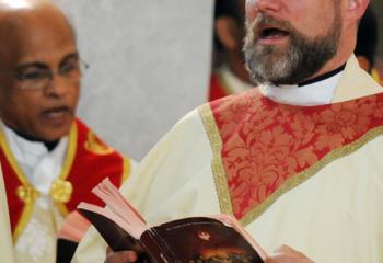 Father Keith Laskowski, pastor of Our Lady of Mercy, Easton, sings with the faithful at the former church that was merged with two other parishes to form Our Lady of Mercy.  