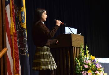 Jianna Alcantara sings the National Anthem to begin the ceremony.