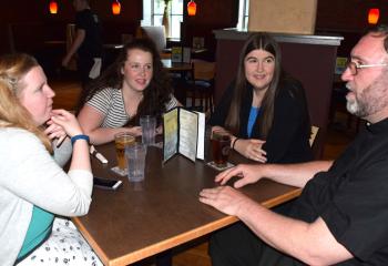 Father Walsh, right, chats during the break with, from left, Maureen Plover, Amy Gehris and Jaclyn Poulton.