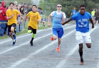 Raphael Wolf, right, of St. Joseph the Worker, Orefield crosses the finish line to win the seventh-grade boys’ 400 ahead of, from left, Zach Neff and Vinnie Slepetz of St. Theresa, Hellertown and Ian Shiery of LaSalle Academy, Shillington. 