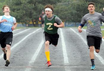 Jacob Festermaker of St. John Neumann Regional School, Palmerton-Slatington, right, crosses the finish line a step ahead of Jared Rodrigez, center, of St. Anne, Bethlehem, and Sam Coppa of LaSalle Academy to win the eighth-grade boys’ 400.