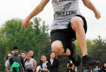 Brandon Norberto of St. Margaret, Reading is high in the air as he competes in the long jump during the meet. 