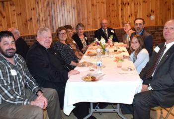 Monsignor William Campion, pastor of Sacred Heart Palmerton, second from left, mingles with a group of Sacred Heart parishioners.