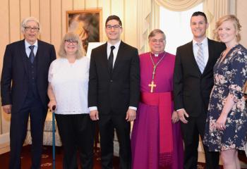 Bishop Alfred Schlert greets the Esposito family before the liturgy, from left, parents Joseph and Debra Esposito, deacon candidate Giuseppe Esposito, and brother and sister-in-law Justin and Alysn Esposito.