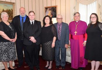 Bishop Alfred Schlert greets the Wehr family before the liturgy, from left, paternal grandmother Linda Wehr, father Dennis Wehr, deacon candidate Zachary Wehr, mother Kathleen Wehr, maternal grandfather Paul Mikulcik and sister Emily Wehr.