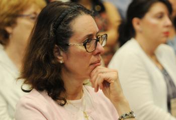 Gia Myers of Douglassville listens to Monsignor Baker’s presentation. (Photo by Ed Koskey)