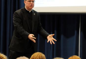 Monsignor Andrew Baker gestures while presenting “A Universal Invitation: Embracing the Call to Holiness.” (Photo by Ed Koskey)