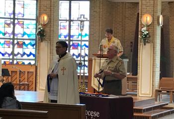 Father Eric Tolentino, left, and Bernard Hofmann prepare to distribute the awards.