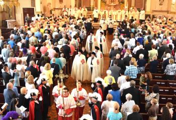 Altar servers lead the Knights of the Holy Sepulchre during the recessional.