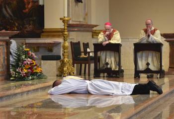 Then Deacon Hutta prostrates himself before the altar as Bishop Emeritus Edward Cullen, left, and Bishop Timothy Senior pray the Litany of Supplication.
