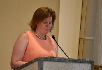 JoLynn Shelton, sister of Father Hutta, offers a reading during the Mass.