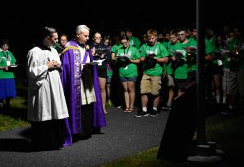 Seminarian Philip Maas, left, and Deacon John Maria lead the July 18 Stations of the Cross.