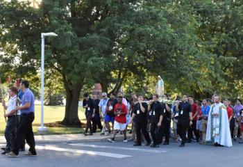 Clergy and religious join with boys and girls July 15 for Rosary Procession and Mary Crowning from Christ the Teacher Statue to Connolly Chapel.