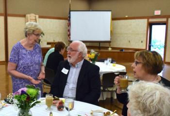 Sister Janice Marie Johnson, left, major and planned gifts officer, welcomes new member James Foley to the luncheon.