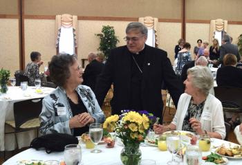 Bishop Schlert, center, chats with Alexandra Zeroka, left, and Judith Stefanik at St. Thomas More, Allentown.