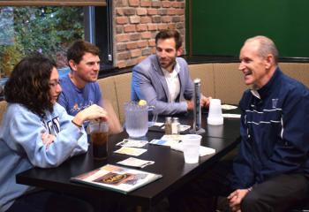 Father Hagan, right, talks with young adults, from left, Cory Fredrick, Rob Kehoe and Will Hanlon.