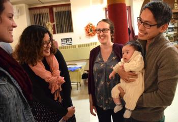 Allan and Theo Aclo, and their son, William, right, meet Ruth Deguire, left, and Mercedes Peveira during the social. 