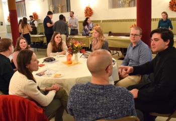 Alexander Brown, right, diocesan seminarian, mingles with a group of young adults.