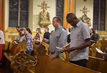 Young adults pray the Psalms during the Vespers.