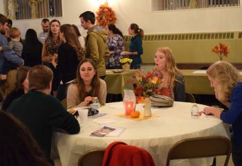 Young adults mingle and enjoy refreshments after praying together during Vespers.