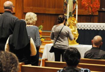 Faithful venerate one of the relics of the Portuguese Catholic priest at St. Anthony of Padua, Easton. (Photo by Ed Koskey)