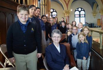 Sister Mary Glackin, IHM, and the Trinity Choir gather in the choir loft to sing for the special Mass.