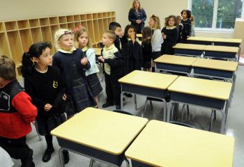 Kindergarten teacher Tammy Heidecker and her students check out their classroom in the Early Learning Center across the street from Immaculate Conception School.