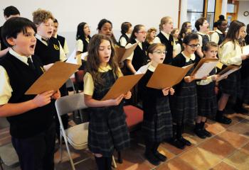 The Immaculate Conception School Choir sings during the liturgy.