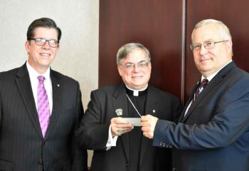 George Halcovage, left, and John Fitzpatrick present Bishop Schlert with a $2,310.63 check from the Knights of Columbus Christopher Fund for the Bishop’s charitable donations. Bishop Schlert directed that half of the Christopher Fund check be directed toward the Retirement Fund for Diocesan priests and the other half directed toward the Carmelite Monastery of St. Theresa, Coopersburg.