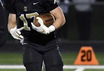 Myers in action on the football field as a defensive back for the Saints.