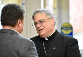 Bishop Schlert chats with one of the men participating in the conference.