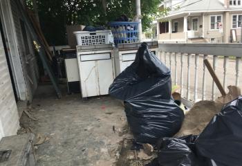 Appliances and debris are removed from a home that suffered catastrophic damage from back-to-back flooding.