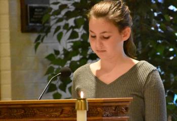 Victoria Temple leads the prayer of the second decade of the rosary at Assumption BVM. (Photo by John Simitz)