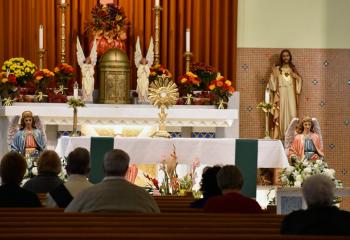 Faithful meditate during adoration at Sacred Heart, Bethlehem. (Photo by John Simitz)