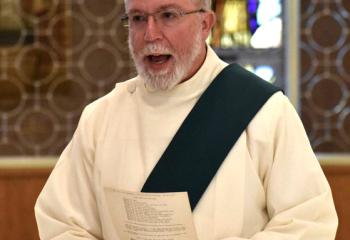 Deacon Hugh Carlin, assigned to Sacred Heart, participates in prayer at the Holy Hour. (Photo by John Simitz)