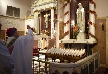 Bishop of Allentown Alfred Schlert, left, incenses and sanctifies the statue of the Blessed Mother as Father John Hutta, right, assistant pastor of Sacred Heart, West Reading, joins him in prayer. 