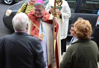 Bishop Schlert greets the faithful after celebrating Mass highlighting the rosary. 