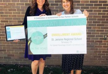 Amy Hannis-Miskar, principal of St. Jerome Regional School, Tamaqua, left, and advancement director Manda Smarr Beers show the school’s SAGE award after receiving it Nov. 8.