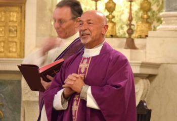 Jesuit Father Thomas Kuller welcomes women at the start of Mass to the Jesuit Center for Spiritual Growth, Wernersville.