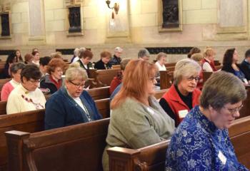 Women pray together during Mass in the Main Chapel.