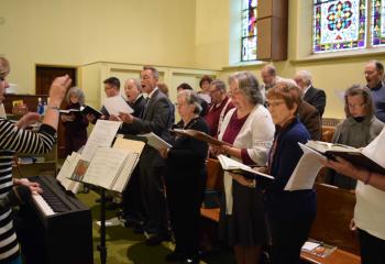 A joint choir from Immaculate Conception and St. Joseph, Jim Thorpe directed by Amy De Puy, left, provides music for the liturgy. 