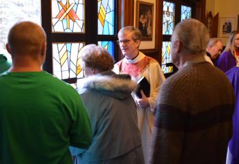 Father Lamb, left, and Father James Ward, pastor of Immaculate Conception who also was a concelebrant, right, greet parishioners after the Mass.